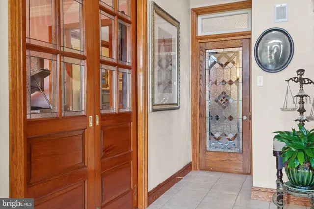 a living room with furniture a fireplace and a large window