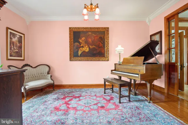 a dining room with furniture window wooden floor and a chandelier