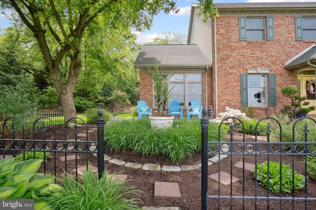 a view of a garden with a building in the background