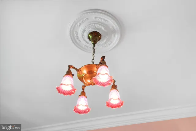 a view of a hallway with a chandelier and living room view
