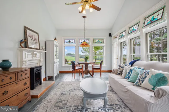 a bed sitting in a spacious bedroom next to a window
