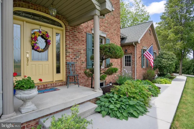 an aerial view of a house with a garden and trees