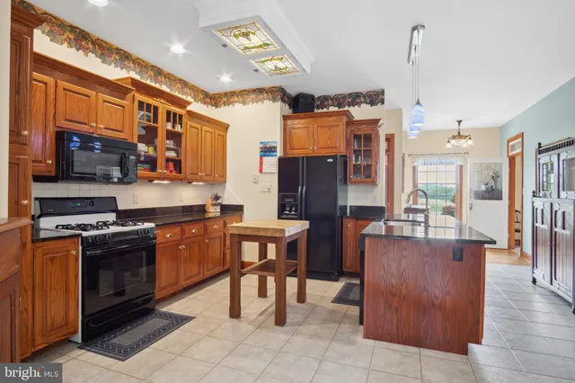 a front view of a house with a garden and trees