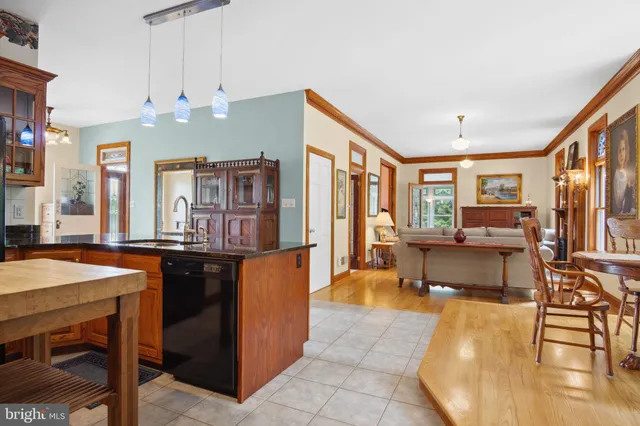 a front view of a house with a garden and trees