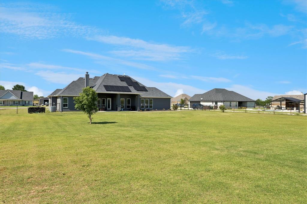 112 Friendship Way Boyd, TX 76023 - Photo 24 of 29 Expansive green lawn with a newly planted tree