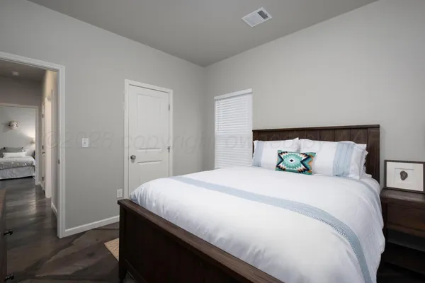 a bedroom with a bed and wooden floor