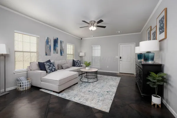 a living room with furniture and a chandelier