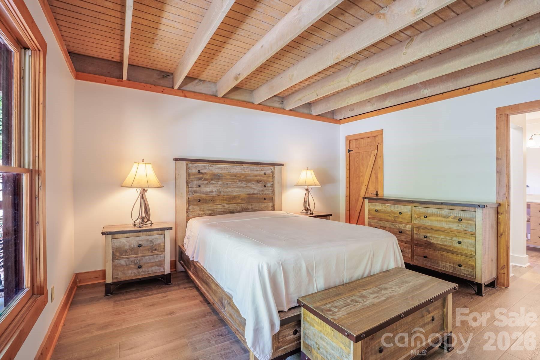 440 Huskey Road Bryson City, NC 28713 - Photo 14 of 42 a bedroom with a bed and a night stand