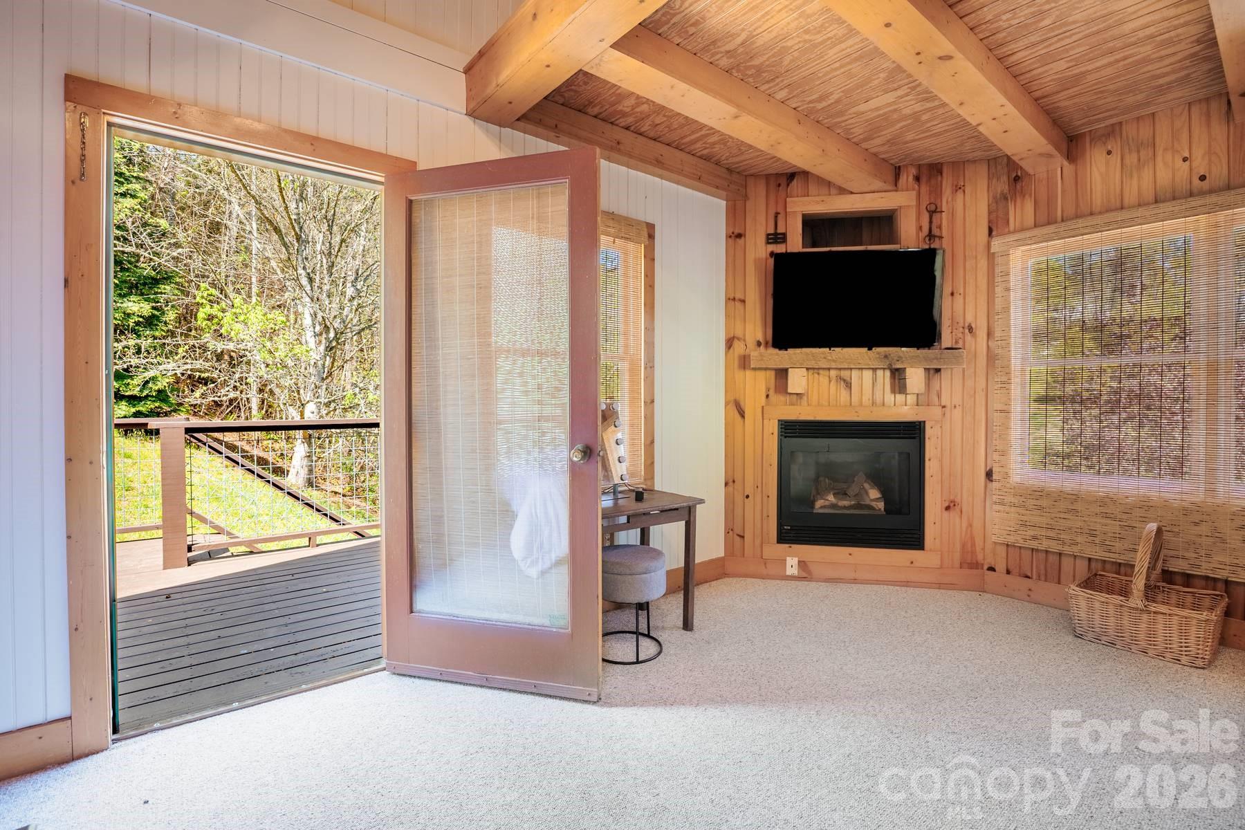 440 Huskey Road Bryson City, NC 28713 - Photo 23 of 42 a living room with furniture a flat screen tv and a fireplace