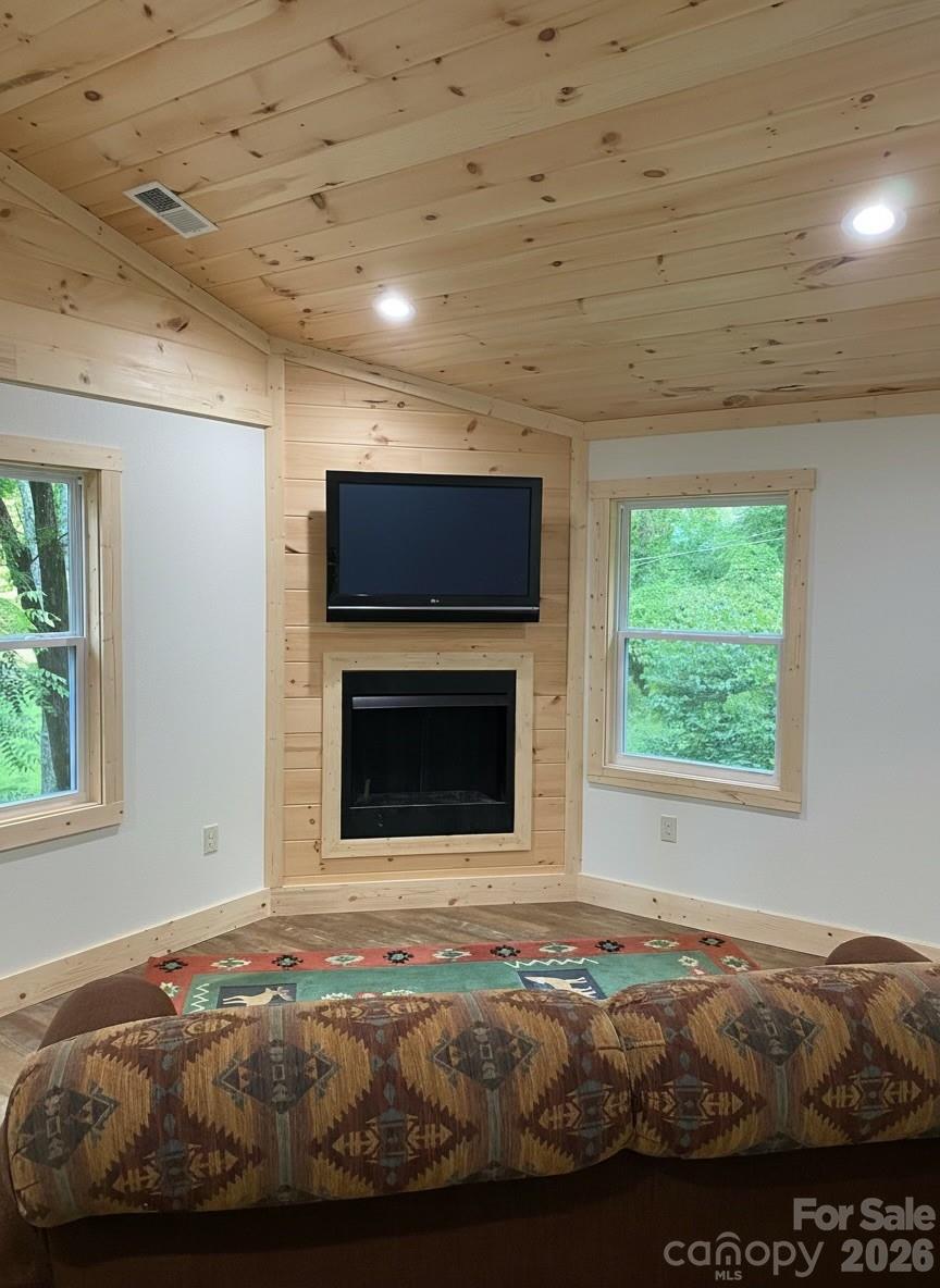 440 Huskey Road Bryson City, NC 28713 - Photo 27 of 42 a bedroom with bed and a fireplace