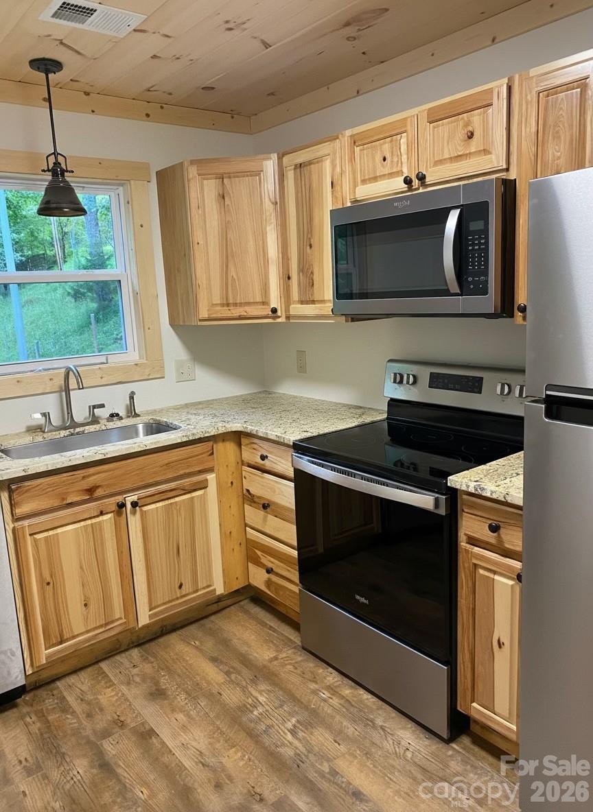 440 Huskey Road Bryson City, NC 28713 - Photo 28 of 42 a kitchen with stainless steel appliances granite countertop a sink stove and microwave