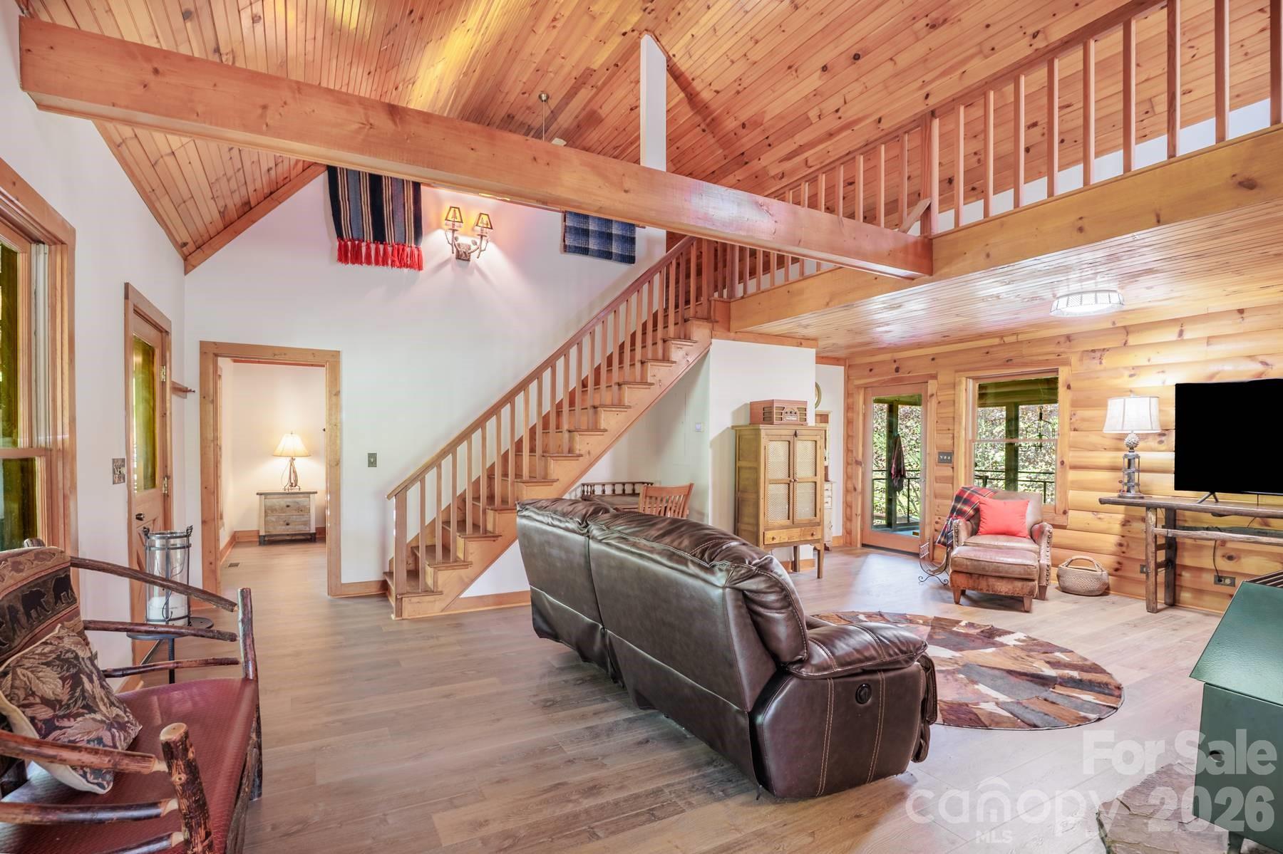 440 Huskey Road Bryson City, NC 28713 - Photo 6 of 42 a living room with furniture a flat screen tv and large windows