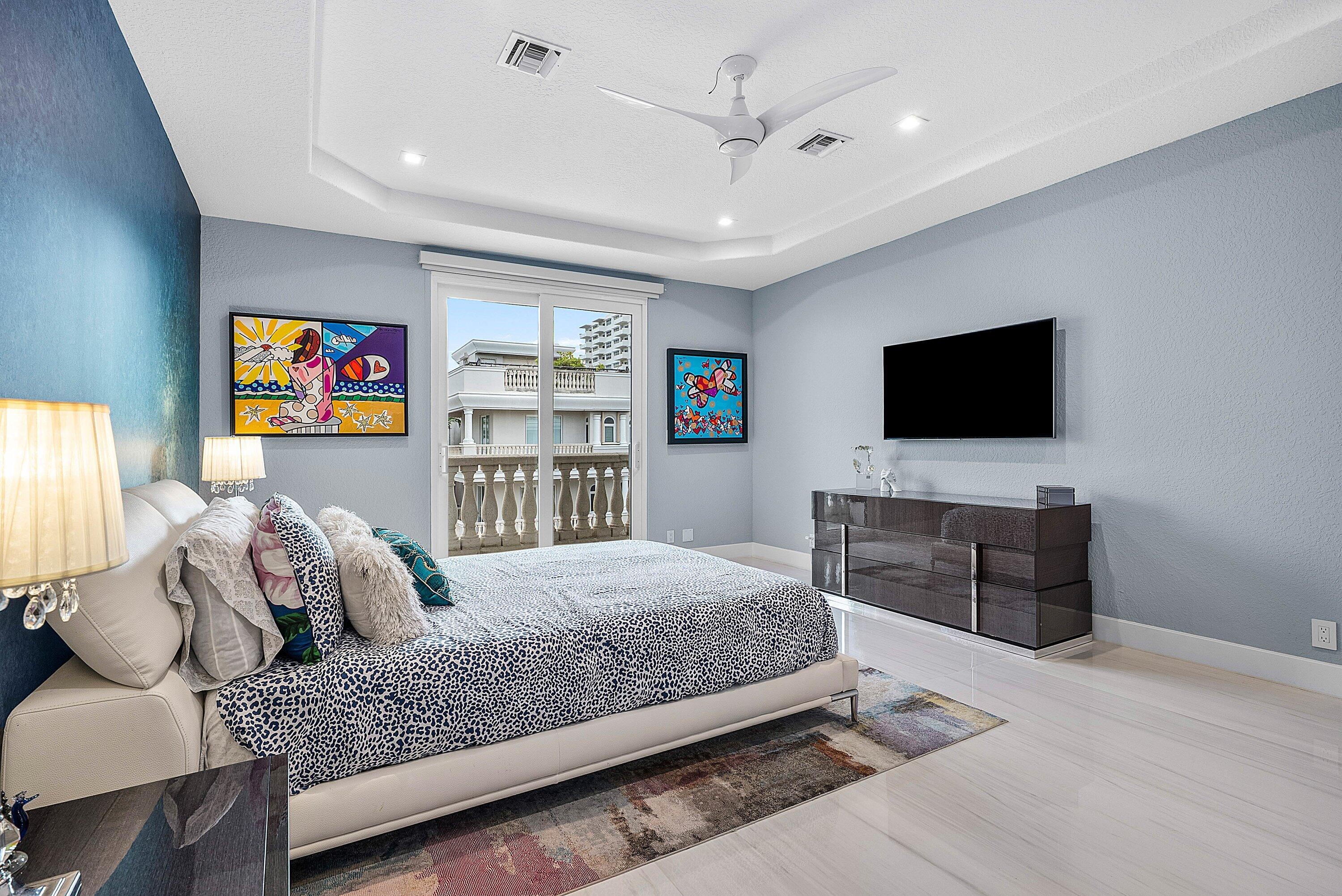 1792 Bay Drive, Unit 27 Pompano Beach, FL 33062 - Photo 24 of 51 a bedroom with a bed and a flat screen tv