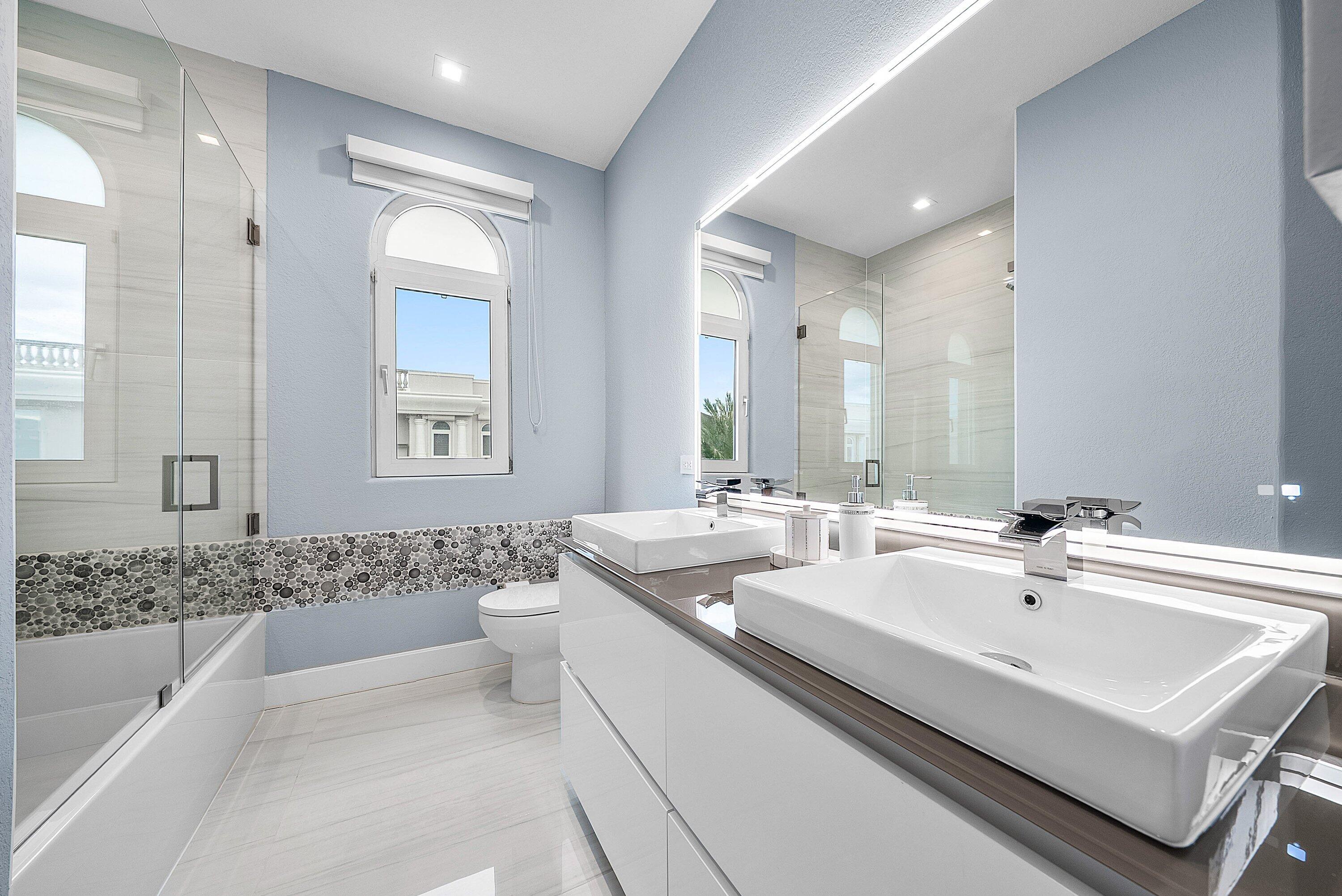 1792 Bay Drive, Unit 27 Pompano Beach, FL 33062 - Photo 30 of 51 a bathroom with a sink tub double vanity and mirror