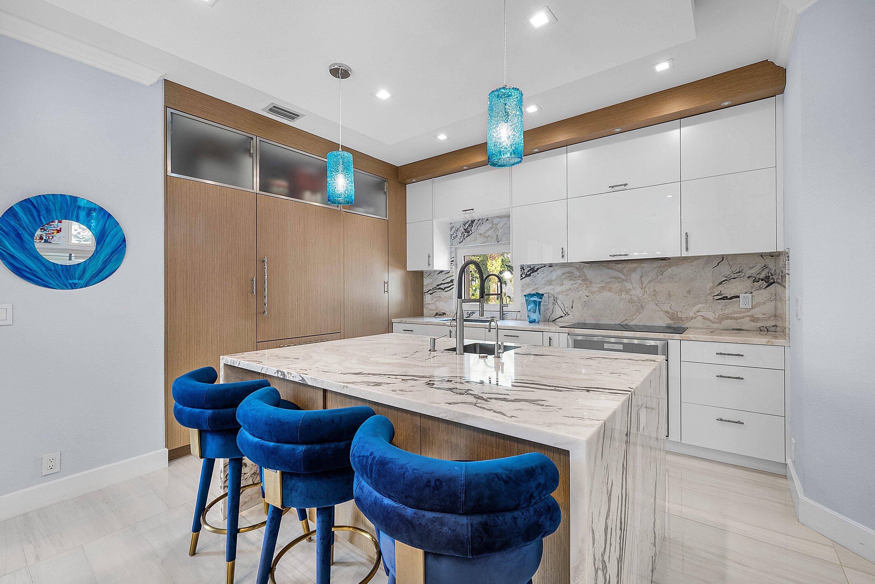 1792 Bay Drive, Unit 27 Pompano Beach, FL 33062 - Photo 5 of 51 a kitchen with kitchen island granite countertop a sink cabinets and wooden floor