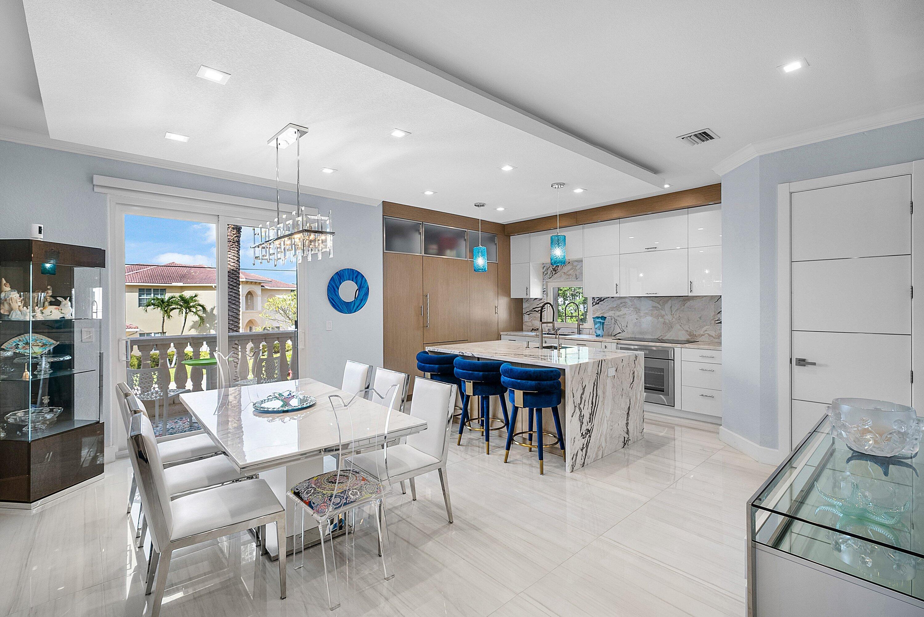 1792 Bay Drive, Unit 27 Pompano Beach, FL 33062 - Photo 9 of 51 a kitchen with a dining table chairs and large window