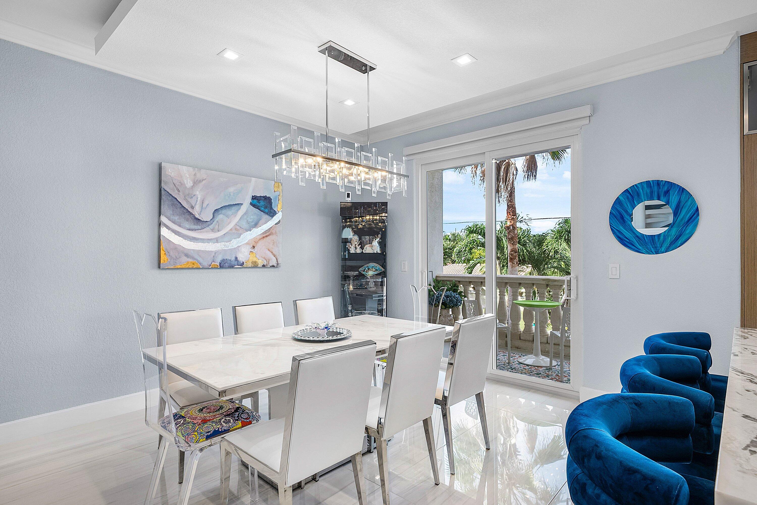 1792 Bay Drive, Unit 27 Pompano Beach, FL 33062 - Photo 10 of 51 a dining room with furniture a window and a chandelier