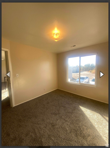 102 East Richelman Lane Wellington, UT 84542 - Photo 8 of 39 Empty room featuring carpet floors and baseboards