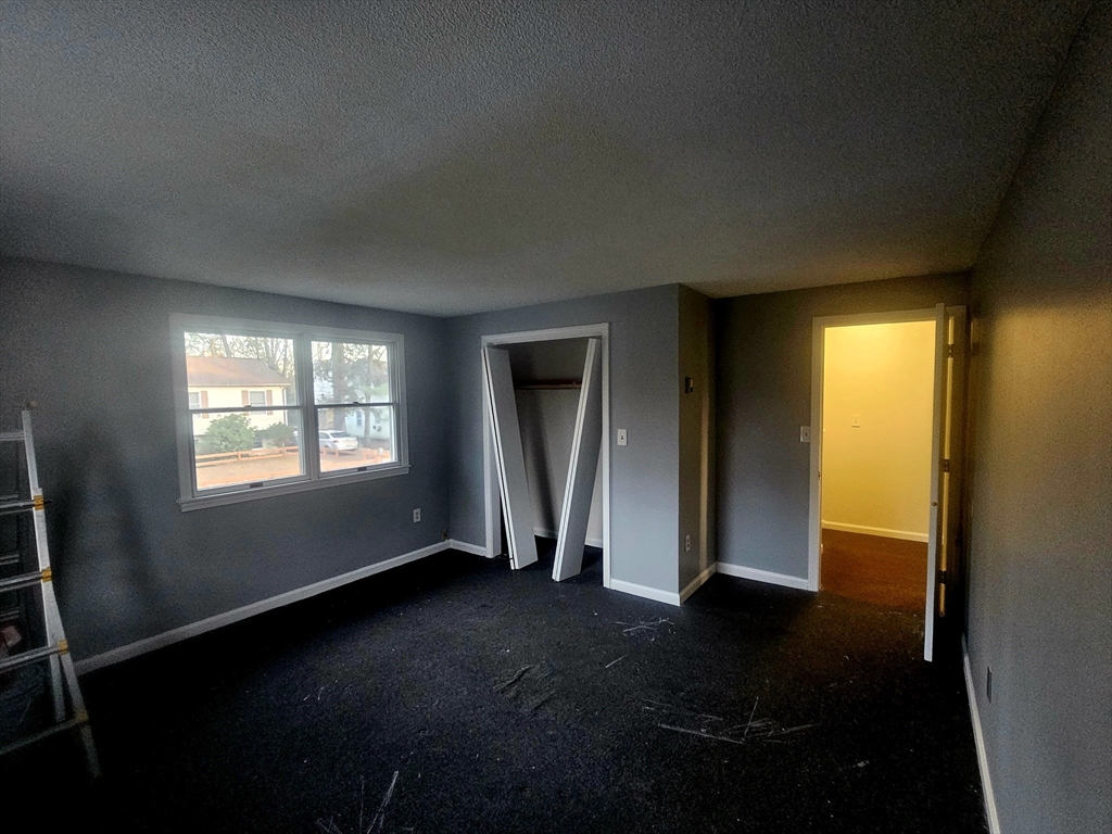 88 Albert Avenue, Unit 2 Springfield, MA 01151 - Photo 14 of 17 a view of empty room with wooden floor and fan