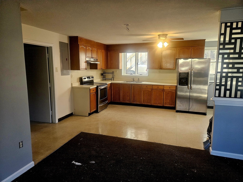 88 Albert Avenue, Unit 2 Springfield, MA 01151 - Photo 4 of 17 a kitchen with granite countertop a refrigerator and a stove