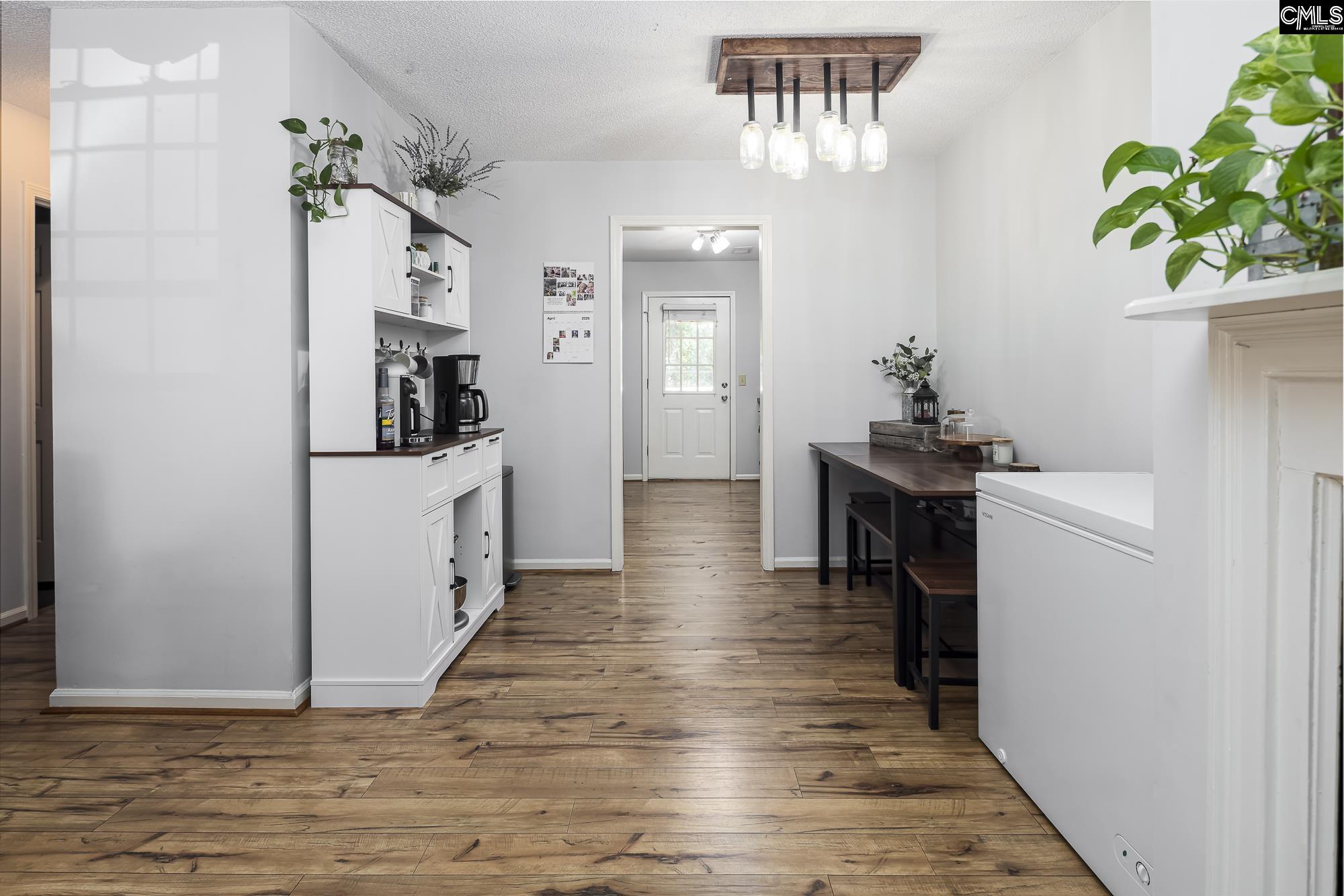 152 Thames Valley Court Irmo, SC 29063 - Photo 12 of 32 a view of a hallway with wooden floor and a potted plant