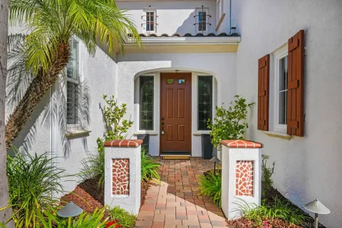 a front view of a house with plants