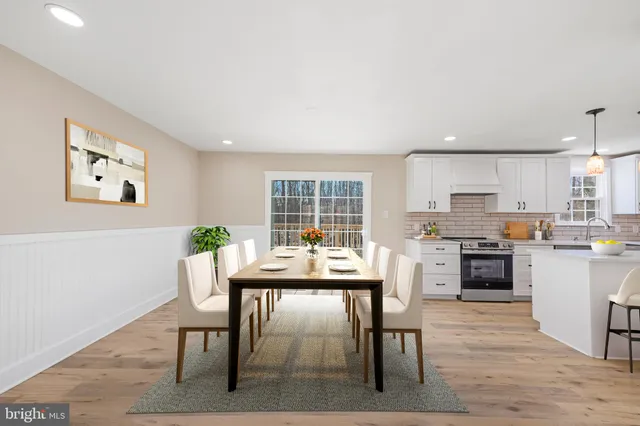 a large kitchen with granite countertop a stove top oven a sink a counter space and cabinets