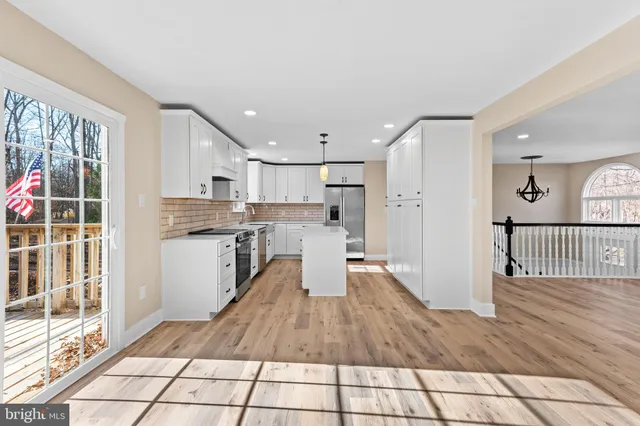 a kitchen with cabinets stainless steel appliances and a counter space