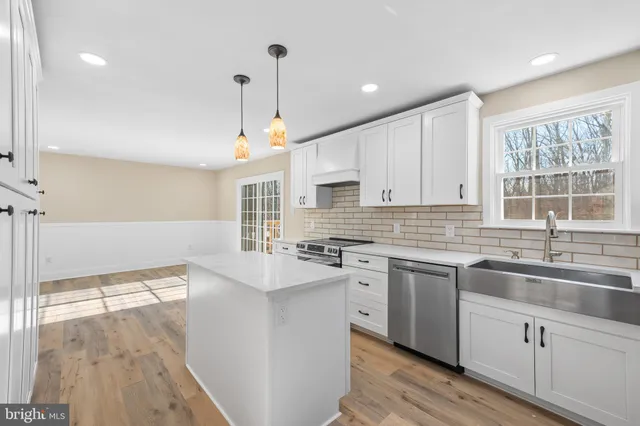 a bathroom with a toilet a sink and a mirror