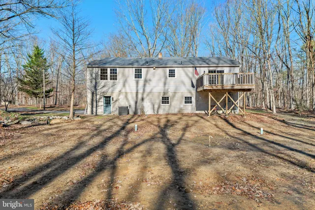 a view of staircase with lots of frames on wall and a window