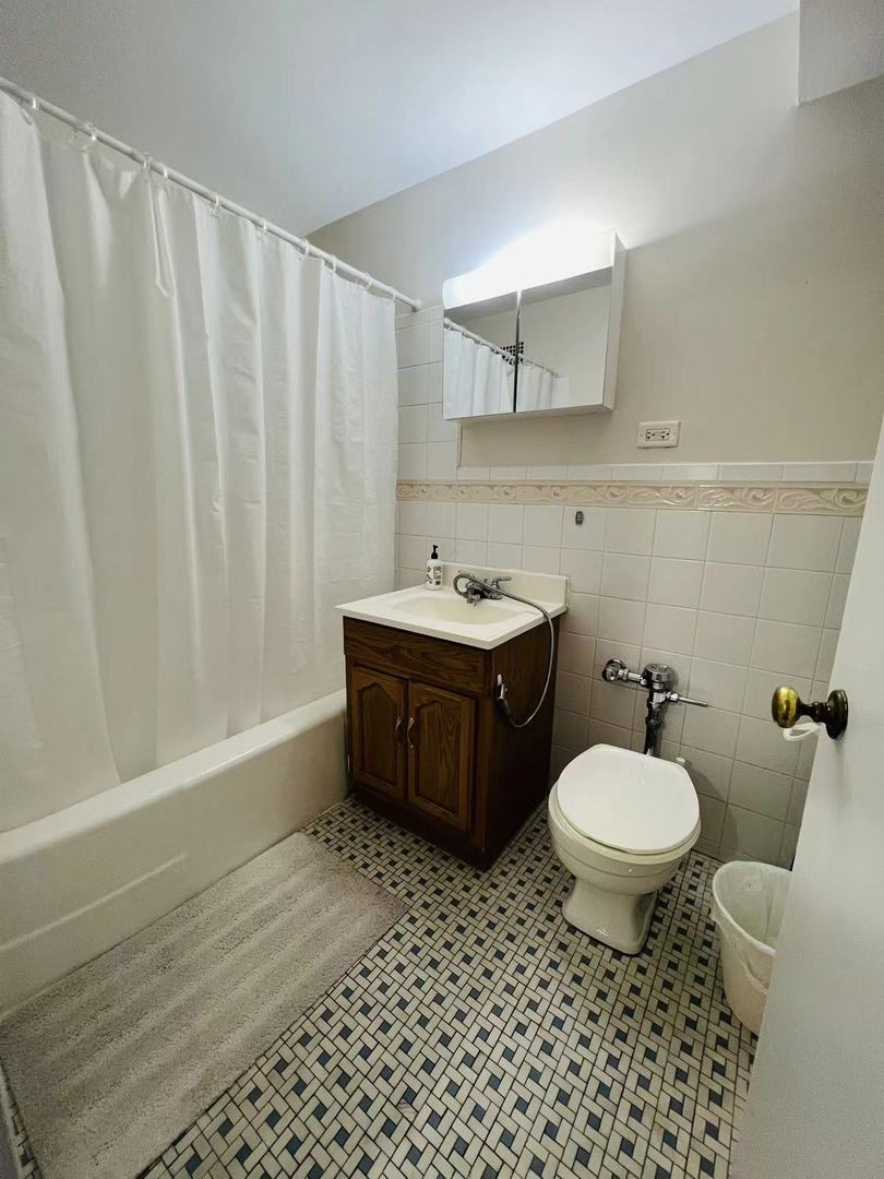 6030 North Sheridan Road, Unit 811 Chicago, IL 60660 - Photo 6 of 6 a bathroom with a sink toilet and shower