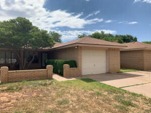 a backyard of a house with yard and garage