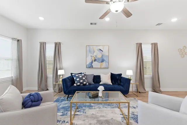 a living room with furniture and a large window