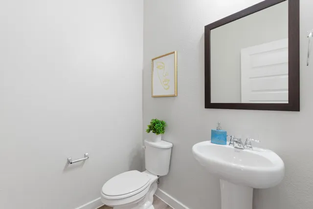 a bathroom with a sink a mirror and a toilet