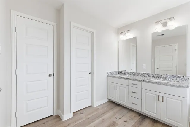 a bathroom with a granite countertop sink and a mirror