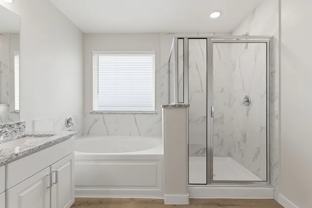 a white bath tub sitting next to a bathroom