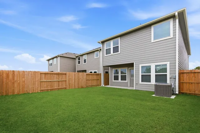 a view of house with backyard and garden