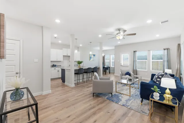 a living room with furniture and wooden floor
