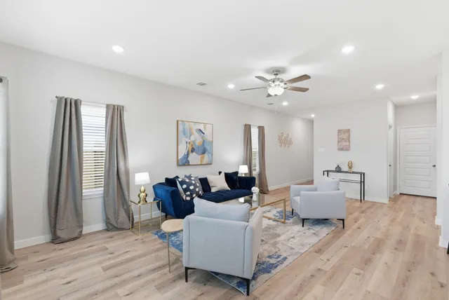 a living room with furniture and a chandelier
