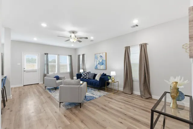 a living room with furniture and a chandelier