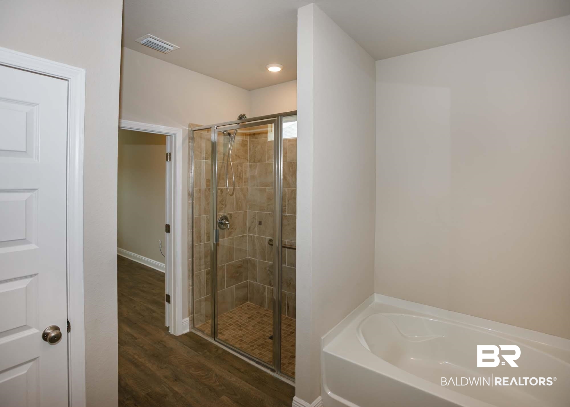 1436 Kairos Loop Foley, AL 36535 - Photo 26 of 52 Full bath with a stall shower, a garden tub, and wood finished floors