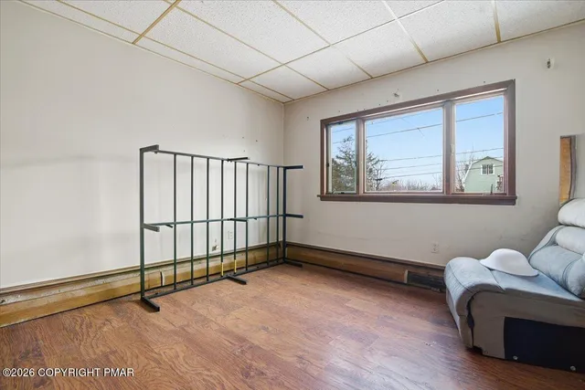 a room with table chairs and wooden cabinets