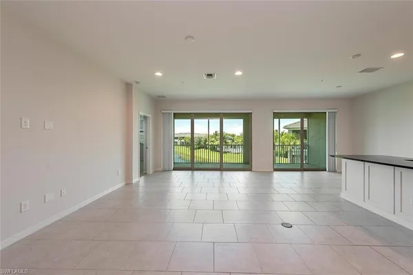 a view of an empty room with windows