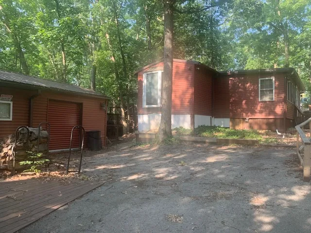 a backyard of a house with table and chairs