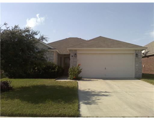 a view of a house with a yard and a garage