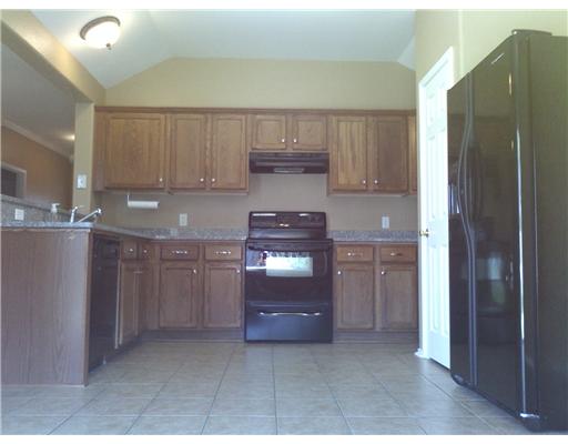 1122 La Mirada Portland, TX 78374 - Photo 6 of 10 a kitchen with stainless steel appliances granite countertop a refrigerator and a stove