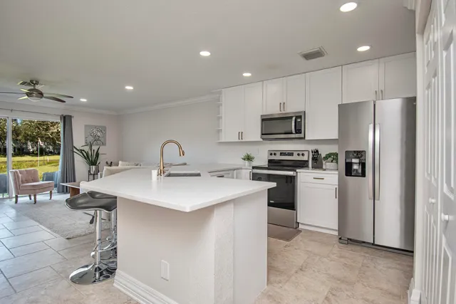 a kitchen with a sink stainless steel appliances and cabinets