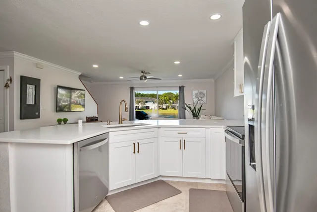 a kitchen with white cabinets and refrigerator