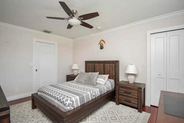 a bedroom with a bed and a chandelier