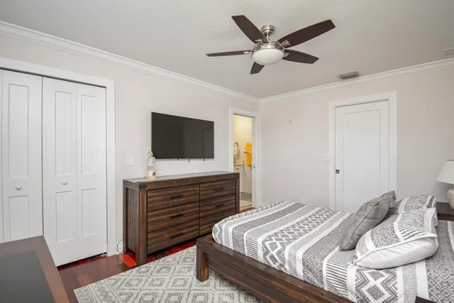 a bedroom with a bed and a flat screen tv